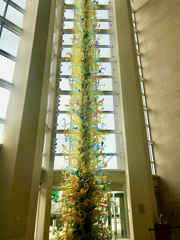 A glass atrium with a glass sculpture that soars to the ceiling at the Oklahoma City Museum of Art