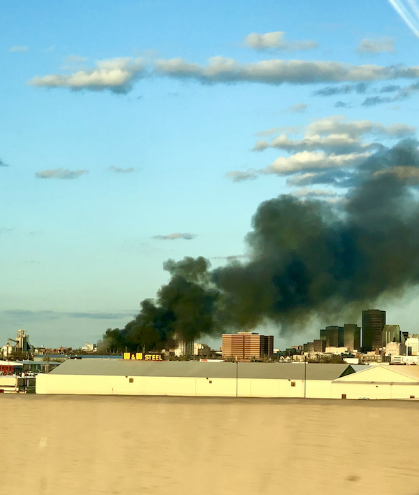 Billowing black smoke from a fires was visible above a rooftop on our way to