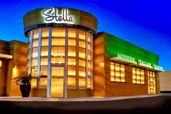 Stella Modern Italian Cuisine OKC is in a brick and glass building with rounded glass entry
