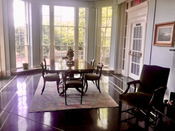 A room with square wood table and chairs and large French doors. This was called the morning room at Cheekwood Estate Nashville TN