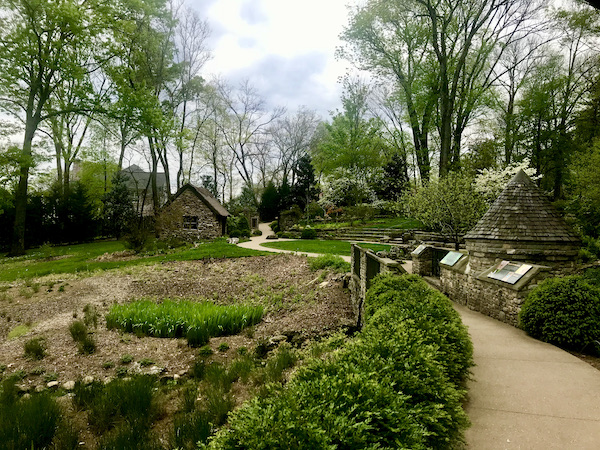 Gardens with curved path and stone buildings at Cheekwood.