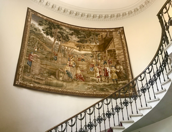 An antique tapestry hanging on the wall by the stairs at Cheekwood Estate Nashville TN