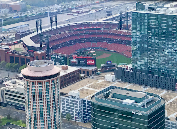 Looking down at a baseball stadium and downtown buildings from the top of the Gateway Arch Saint Louis MO