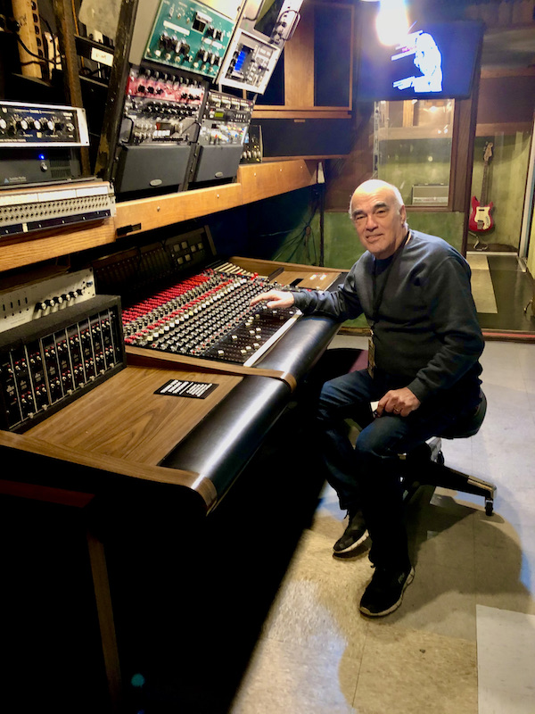 A man sitting in a sound booth at the Musicians Hall of Fame Nashville
