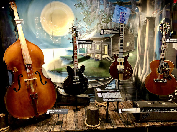 A display of string instruments used by Creedence Clearwater Survival