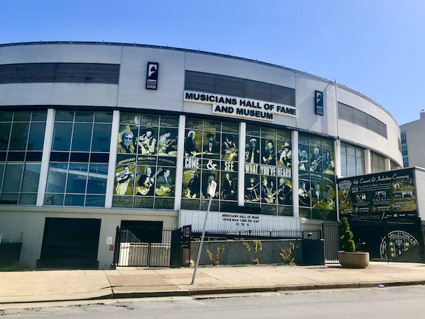 A white curved building that houses the Musicians Hall of Fame Nashville
