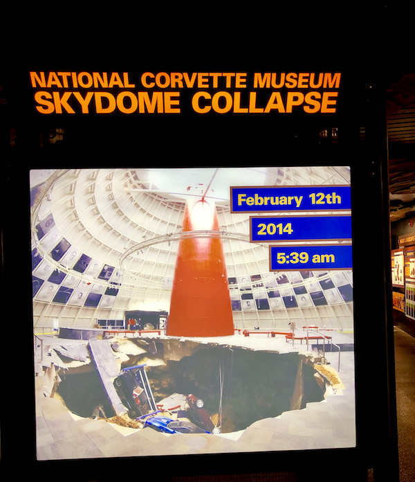 A sign showing the sink hole that took 8 valuable corvettes