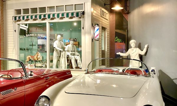 White figures representing people in 1953 showing the new Corvette at the National Corvette Museum