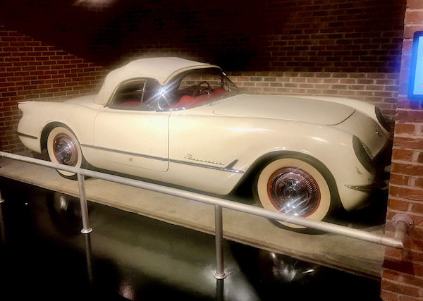 A white sports car with white cloth top at the National Corvette Museum