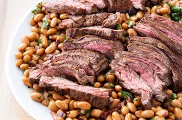 A large salad with meat and pinto beans from A Trio from America's Test Kitchen