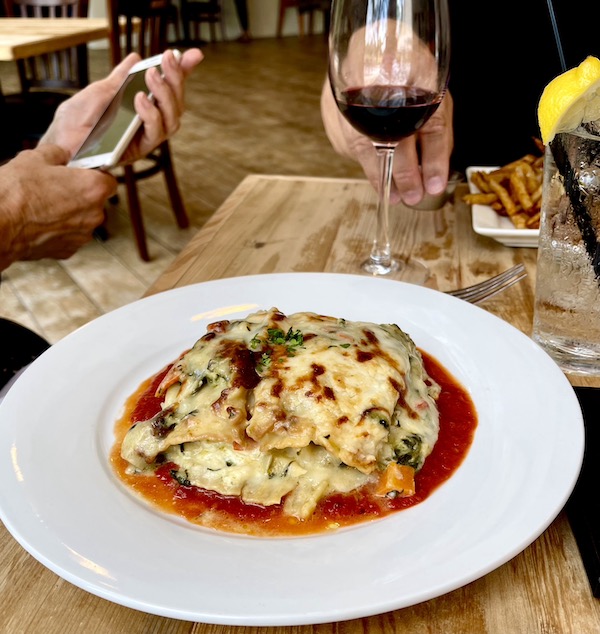 A round white plate topped with vegetable lasagna at Café Hope Gretna Louisiana