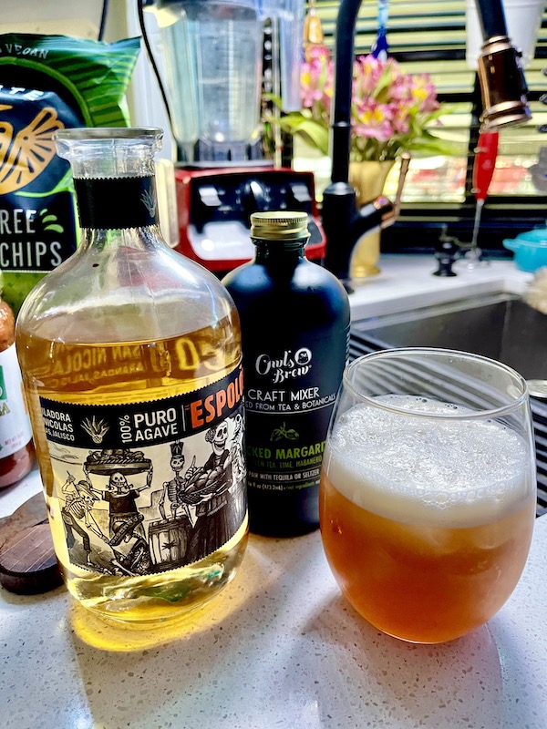 A bottle of gold tequila, margarita a mix and a glass filled with a cocktail from Fabulous Gifts for Campers