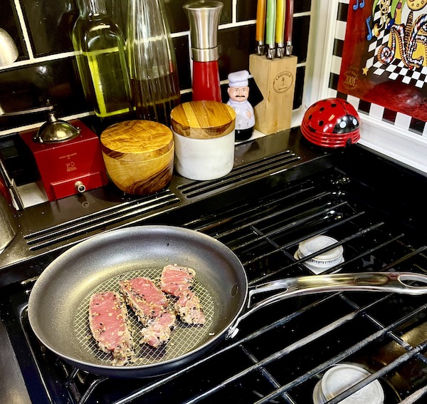 Slices of fresh tuna seared in a grey pan on a gas stove from Fabulous Gifts for Campers