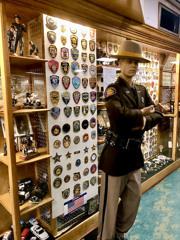 Cases filled with law enforcement badges and patches.