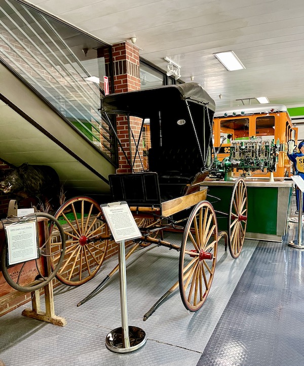 A antique horse drawn carriage for one person.