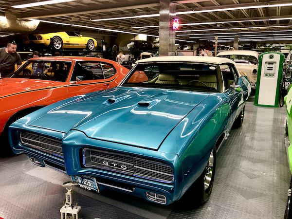 A blue Pontiac GTO with other cars on display at Tallahassee Automobile Museum