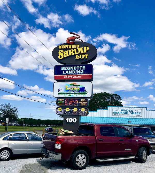 A huge sign at a parking lot announcing the Westwego Shrimp Lot Louisiana
