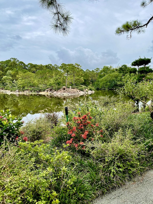 Lush gardens surrounding a small body of water.
