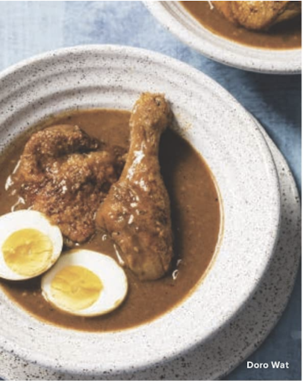 A bowl of chicken stew with chicken legs, brown sauce and 2 hard boiled egg halves from The Complete Autumn and Winter Cookbook