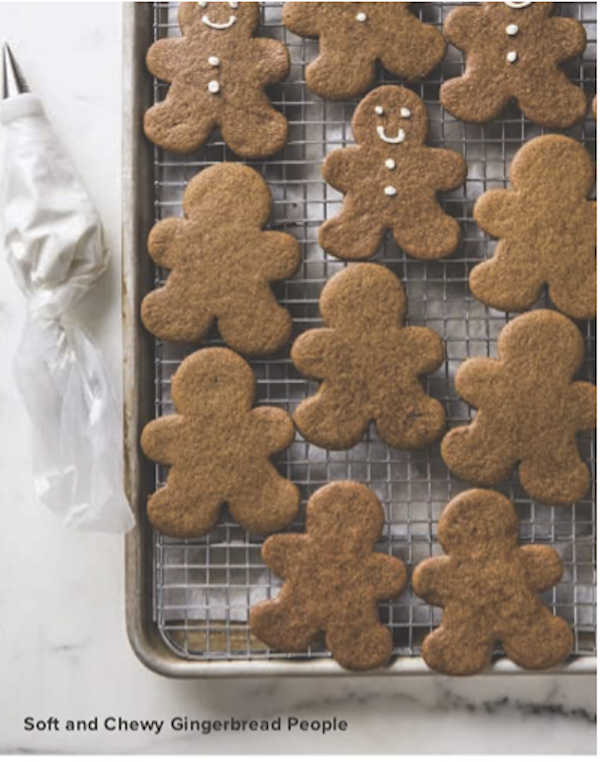 A cookie sheet topped with baked gingerbread people from The Complete Autumn and Winter CookbookThe front cover of a cookbook with autumn & winter recipes.