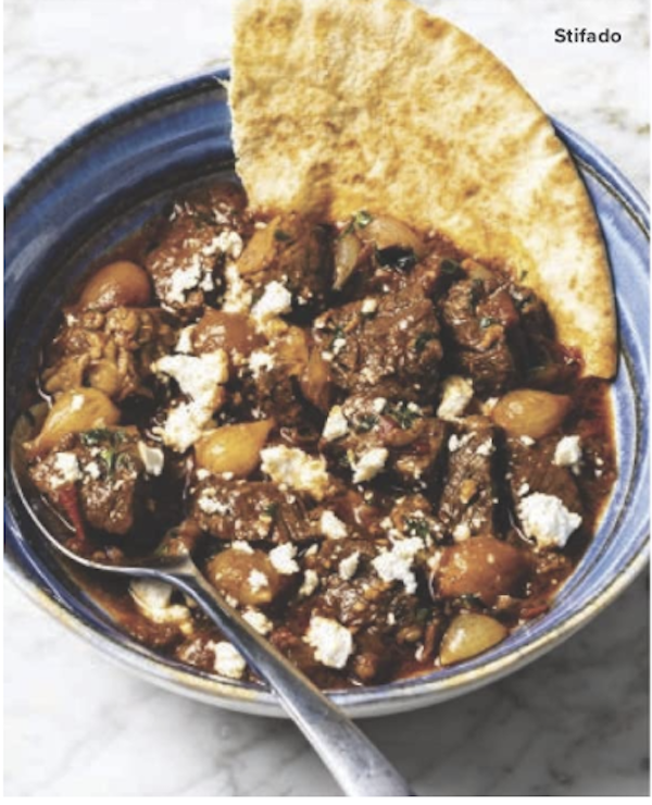 A bowl of beef stew with flatbread emerging from side of bowl from The Complete Autumn and Winter Cookbook