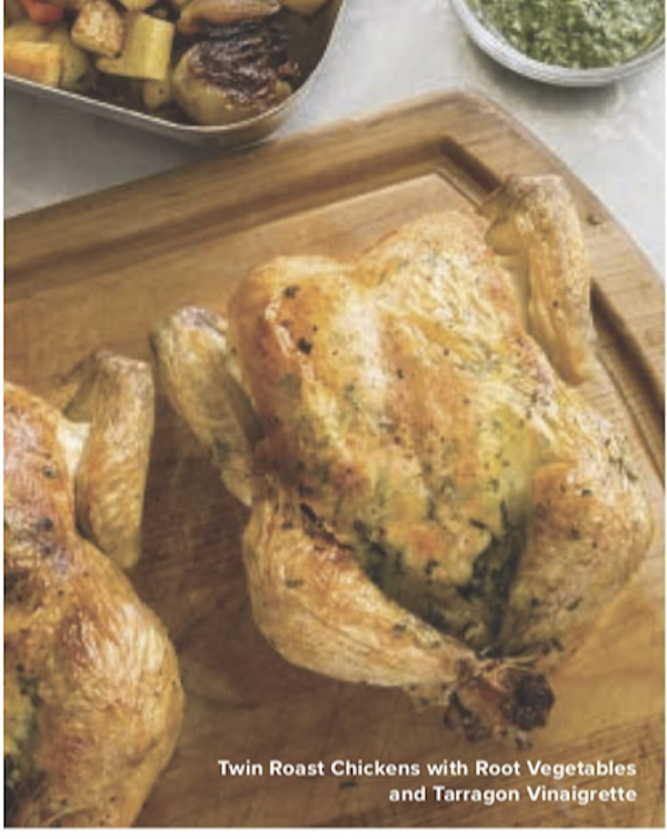 A pair of roasted whole chickens on a cutting board from The Complete Autumn and Winter Cookbook