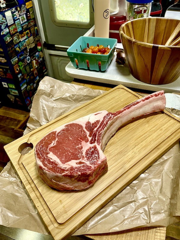 A huge tomahawk steak on a cutting board for Tomahawk Steak on the Grill