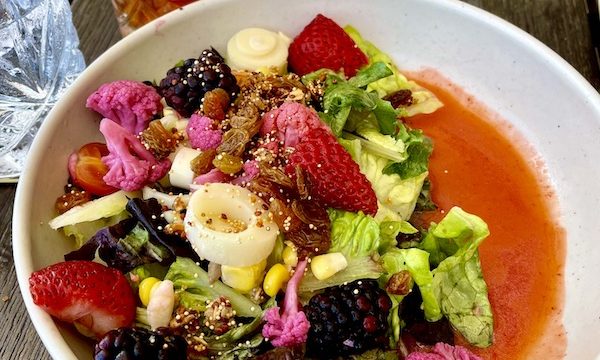 A large shallow bowl with artistically arranged fruit and vegetables at Viva La Playa at Lake Worth Beach