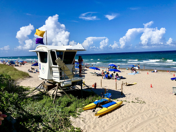 A lifeguard stand on the beach with the ocean.