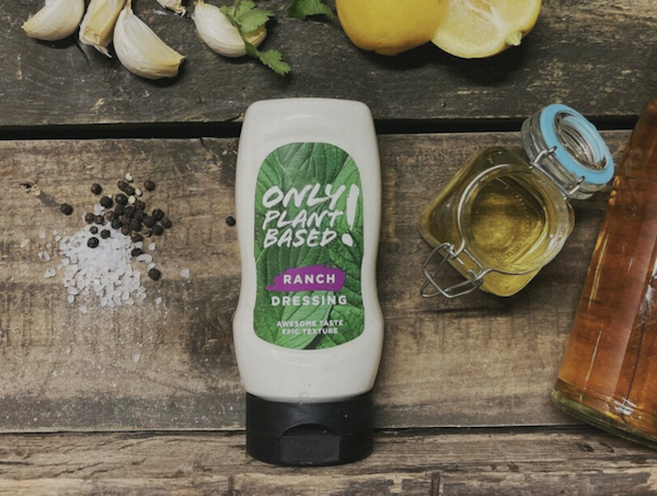 A bottle of ranch dressing on a wood table