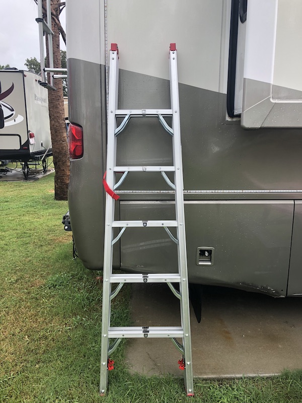 A ladder leaning against the back of an RV