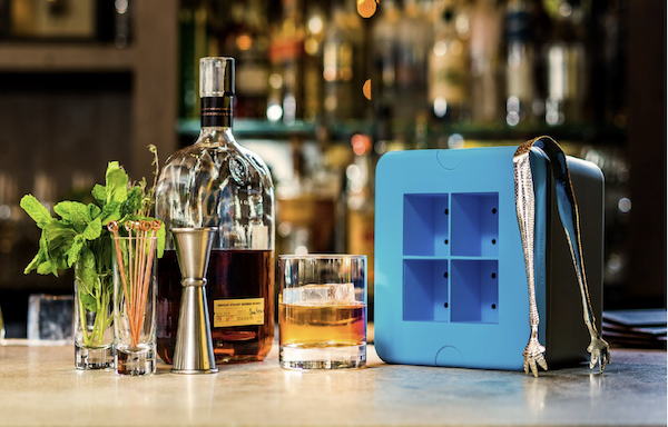 A bottle of whisky and a blue large format ice cube tray from 15 Best Gifts for Foodies and RVers