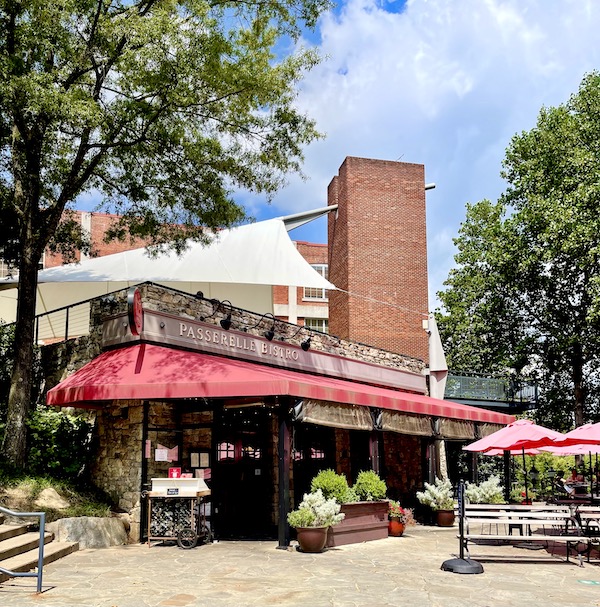 A restaurant with a red awning and outdoor seating in Beautiful Greenville South Carolina