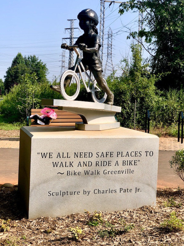 A bronze sculpure of a child riding a bike in Beautiful Greenville South Carolina
