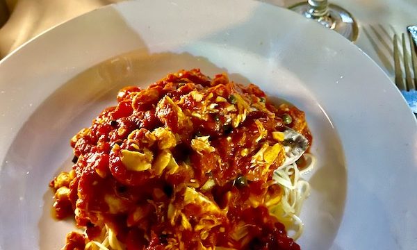 A large white plate topped with noodles, seared tuna, crab, tomatoes capers at La Padella Ristorante Ventnor NJ