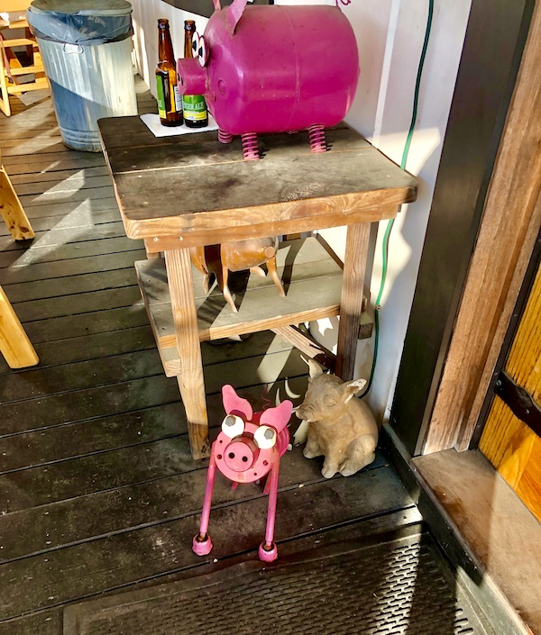 Wood tables and pink pig sculptures in Louisa VA Small Town Big Impact