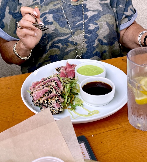 Round white plate topped with slices of seared tuna with black and white sesame seeds, a small bowl of soy sauce and a smaller bowl of wasabi at Mudhen Brewing Wildwood NJ