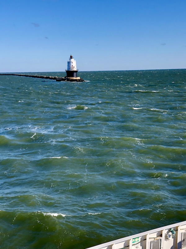 Choppy water, a channel marker and jetty.