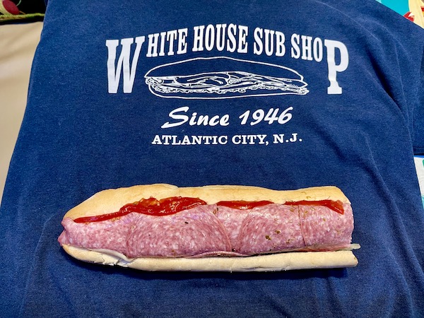 A navy T-shirt with a submarine sandwich displayed on it enjoyed while Revisiting Delaware Seashore State Park