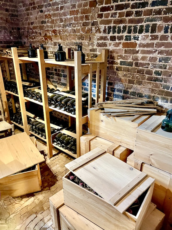 Wine racks and bottles fill room with red brick walls at Thomas Jefferson's Monticello