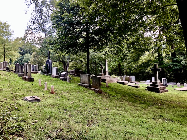 A grassy hill peppered with grave stones and trees at Thomas Jefferson's Monticello