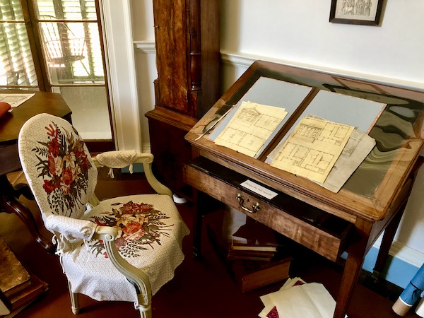 A wood and glass case displaying the blueprints for Thomas Jefferson's Monticello