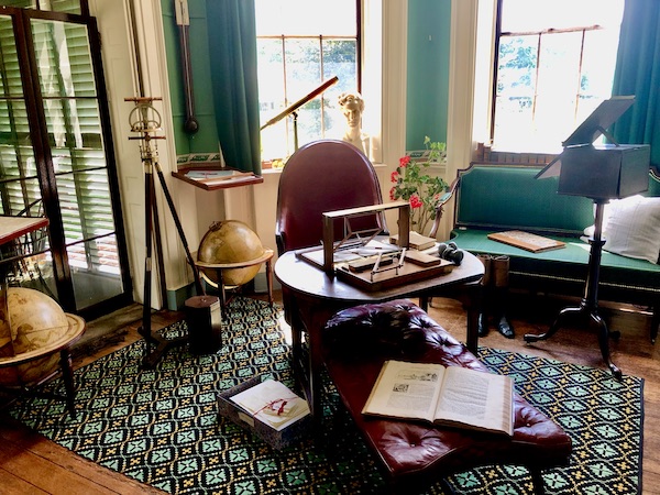 An historic room in Thomas Jefferson's Monticello with globes, telescopes and musical instruments.
