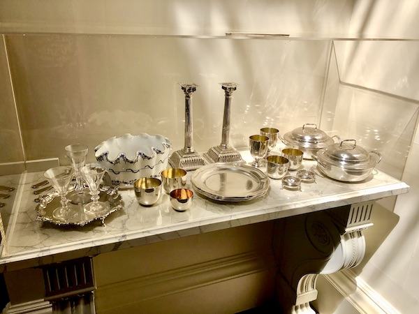 A sideboard with many silver serving pieces on top at Thomas Jefferson's Monticello