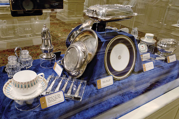 A case filled with china and silver service from Aboard Titanic Pigeon Forge TN