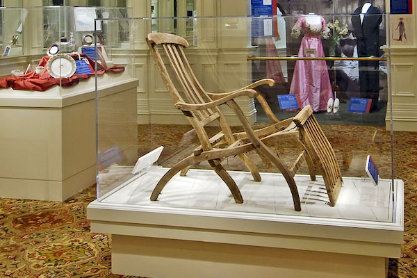 A teakwood deck chair in a display case from Aboard Titanic Pigeon Forge TN