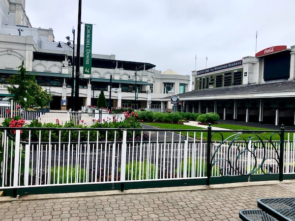 Paved area separated from lawn and landscaping by an iron fence at Churchill Downs Louisville Kentucky
