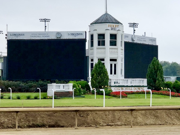 A round white structure with enormous TV screens on either side at Churchill Downs Louisville Kentucky