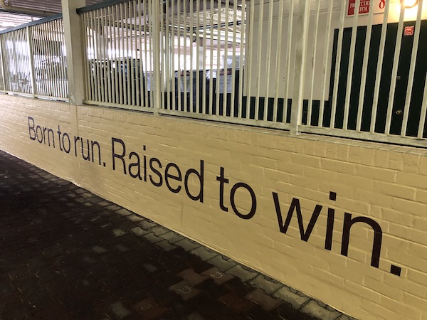 A yellow wall in a walkway from paddock to track at Churchill Downs Louisville Kentucky