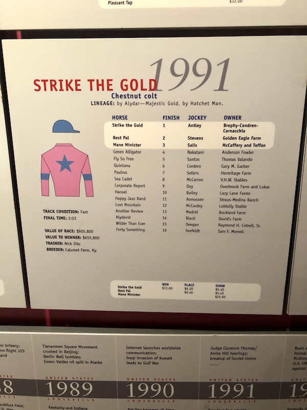A white board with a drawing of a jockey in pink and blue and stats of the 1991 derby winner at Churchill Downs Louisville Kentucky